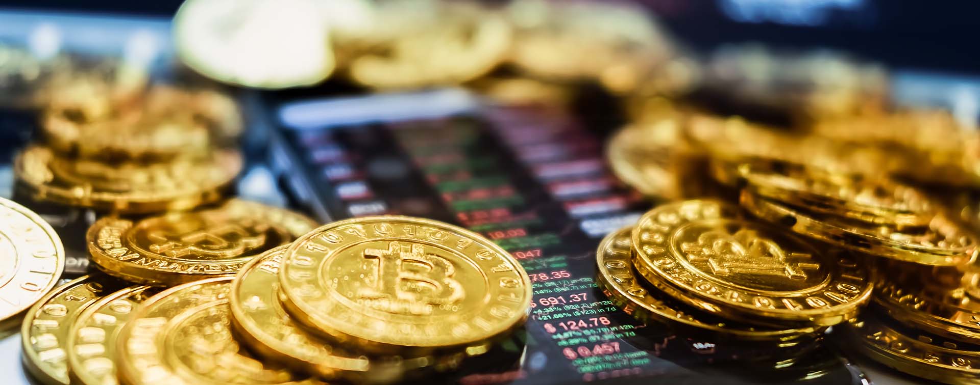 Concept image of gold bitcoins and bitcoin tracking app