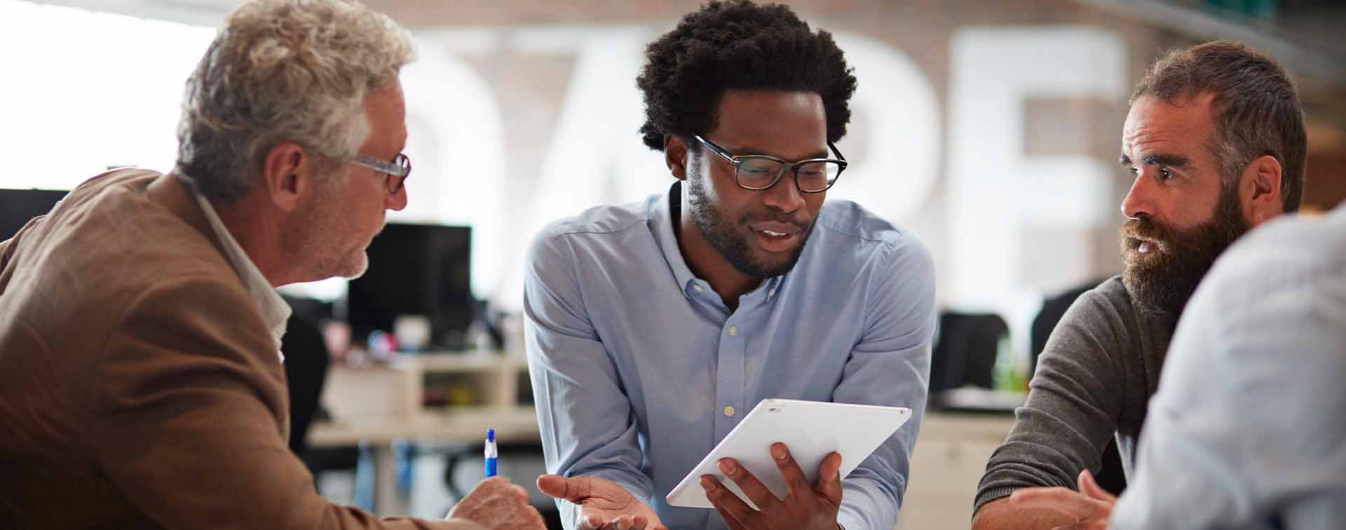 Businesspeople sitting around a table in discussion.