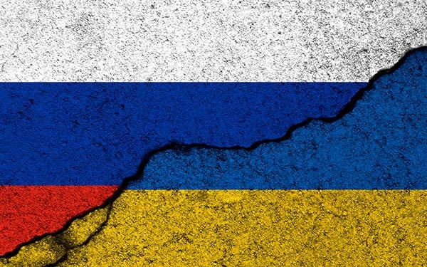 Cracking concrete with a Russian flag overlay cracking to reveal a Ukranian flag underneath.