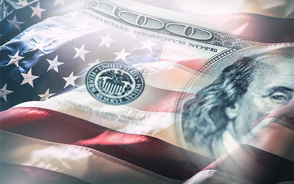 American flag blowing in the wind and 100 dollars banknotes in the background