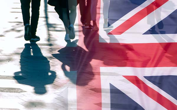  Shadows of people and UK flag citizens of Great Britain